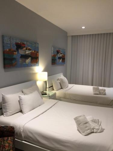 a hotel room with two beds and paintings on the wall at Ocean Front Units at Miami Beach in Miami Beach
