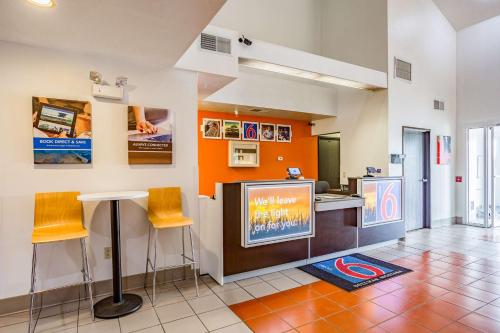 a room with a bar with a tv and chairs at Motel 6-Bozeman, MT in Bozeman