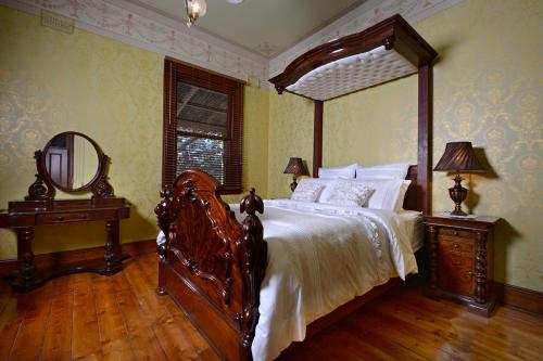 a bedroom with a large bed with a wooden frame at Thornebridge in Murchison