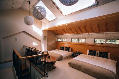 a attic bedroom with two beds and a skylight at Look Bed and Breakfast in Yuchi