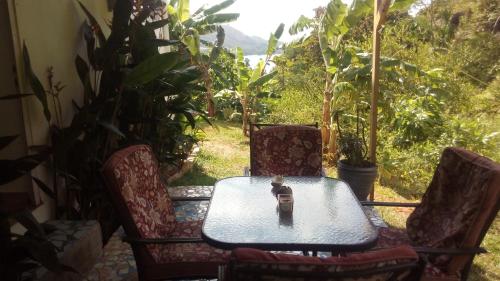 a table and two chairs and a table and a table and chairs at Mirella Villa Holiday Apartment in Anse Possession