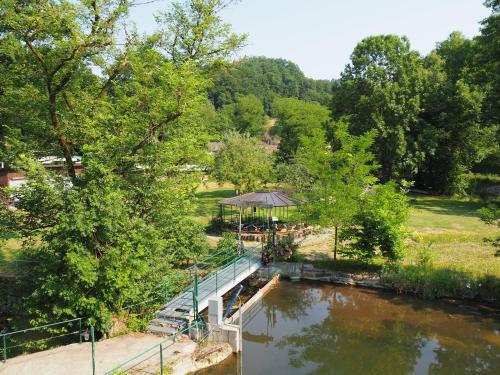 a bridge over a river with a gazebo at Gasthof Sturmmühle in Saxen