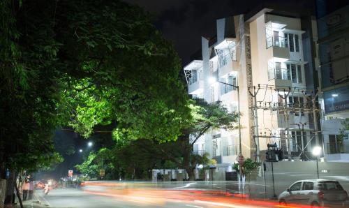 a city street at night with cars and buildings at Treebo Pechis Castle in Chennai