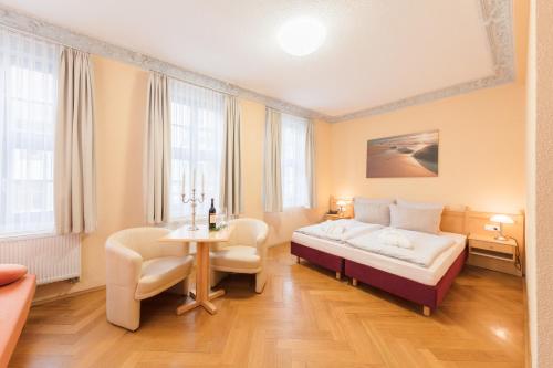 Ένα ή περισσότερα κρεβάτια σε δωμάτιο στο Hotel Mühlhäuser Hof