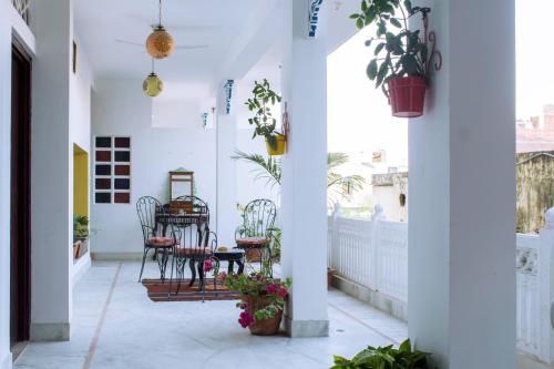 a balcony with a table and chairs and plants at Haveli Kalwara - A Heritage Hotel in Jaipur