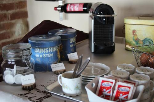 a counter with some food and cups and a coffee maker at Azienda Agricola Garoglio Davide in Alfiano Natta