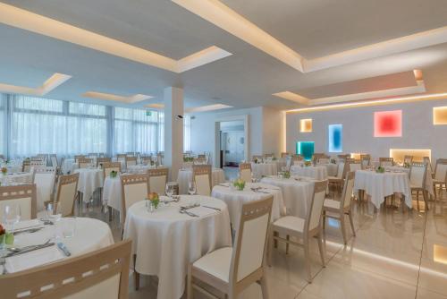 a banquet hall with white tables and chairs at Hotel Terme Venezia in Abano Terme