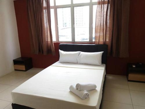Ένα ή περισσότερα κρεβάτια σε δωμάτιο στο T-Hotel Ipoh
