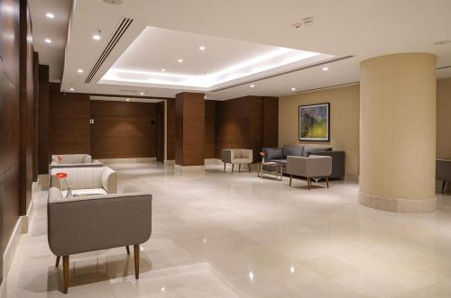 a lobby with couches and chairs in a building at Radisson Blu Hotel Ankara Cankaya in Ankara