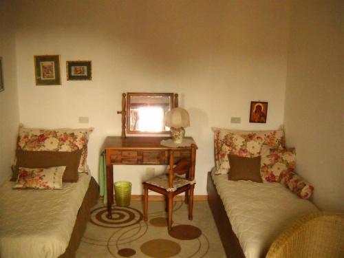 a room with a table and a bed and a desk at B&B ANNA in Forlì