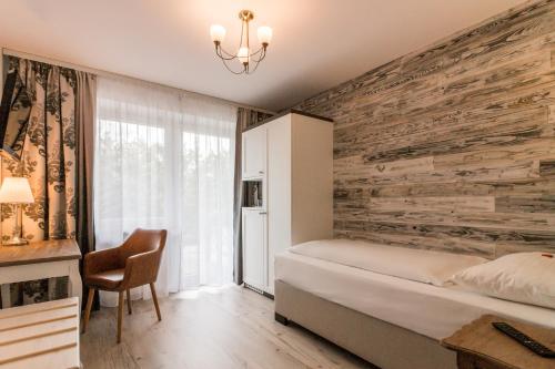 a bedroom with a bed and a wooden wall at Hotel Diana Garni in Malente