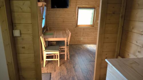 a dining room with a table and chairs in a cabin at Chata Nový Přerov in Nový Přerov