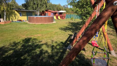 a park with a playground with a swing at Chata Nový Přerov in Nový Přerov
