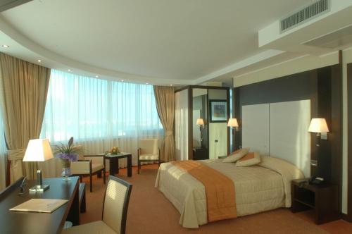 Posteľ alebo postele v izbe v ubytovaní Hotel San Mauro