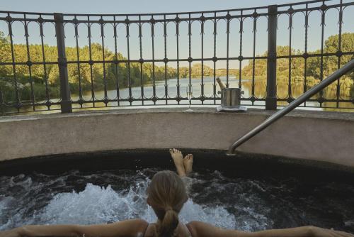 a woman is in a hot tub with water at Hacienda Zorita Wine Hotel & Spa in Valverdón