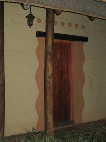 a door in the side of a house with a pole at African Silhouette Guesthouse in Benoni