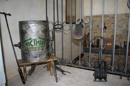 a barrel sitting on a stand next to a fence at Azienda Agricola Garoglio Davide in Alfiano Natta