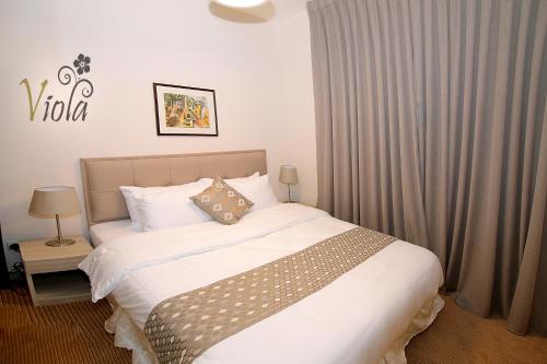 Ένα ή περισσότερα κρεβάτια σε δωμάτιο στο Viola Hotel Suites