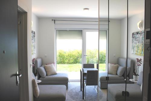 a living room with a couch and a table at Studio apartment Miramare breakfast and parking in Rijeka