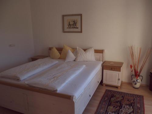 a bedroom with a large white bed in a room at Ferienhaus Sam in Innsbruck