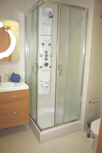 a bathroom with a shower with a glass door at Apartamento T3-S.PedroII in Ponta Delgada