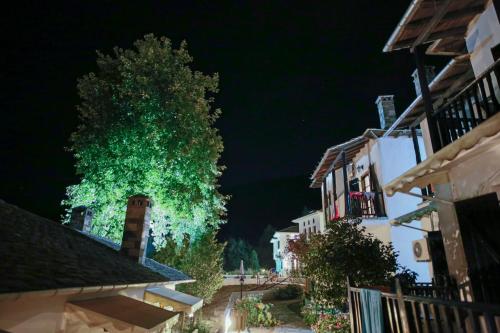 a tree is lighting up a street at night at Pilio Sea Horizon Hotel in Tsagarada
