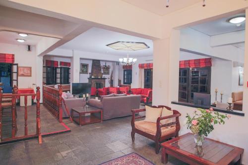 a living room with couches and chairs and a table at Pilio Sea Horizon Hotel in Tsagarada