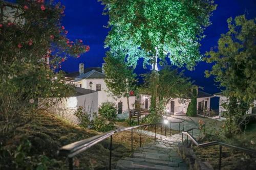 a stairway leading to a white house at night at Pilio Sea Horizon Hotel in Tsagarada