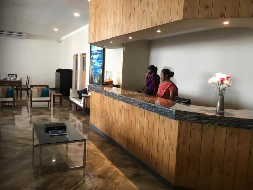 two women standing at a bar in a lobby at Twenty-Two Weligambay in Weligama