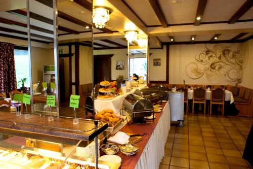 a restaurant with a buffet line with food on display at Landhotel Karrenberg in Kirchberg
