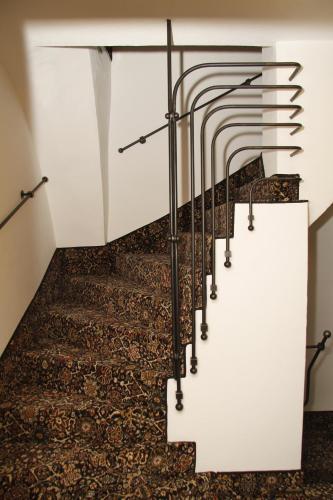 a staircase with metal railings and a carpet at Bed&Bike Prachatice in Prachatice