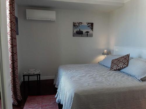 a bedroom with a bed and a picture on the wall at Magnolia Apartment in Funchal