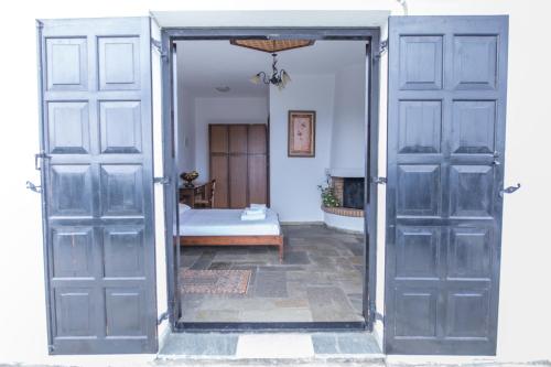 an open door leading to a bedroom with a bed at Pilio Sea Horizon Hotel in Tsagarada