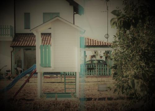 a small house with a gate and a playground at Frăgăria in Zimandcuz