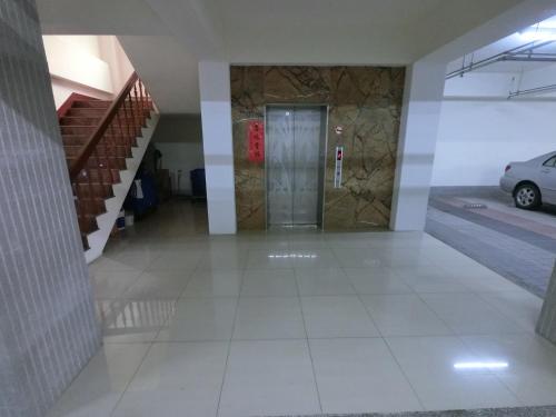 a hallway of a building with a door and a car at 雲林斗六福爾摩莎大飯店 in Douliu