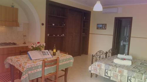 a kitchen with a table with a book on it at Villa Laura Apartment in Giardini Naxos