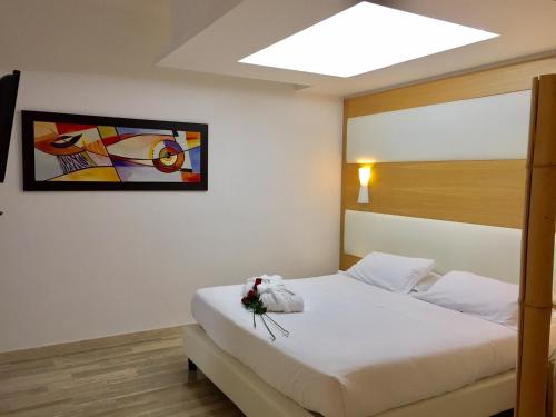 a hotel room with a bed with a flower on it at Hotel Sant'Elia in SantʼElia Fiumerapido