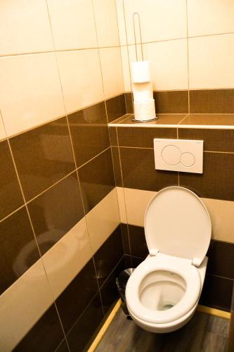 a bathroom with a white toilet in a stall at Hotel Krakonos in Rokytnice nad Jizerou