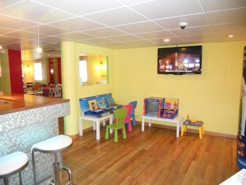 a restaurant with a waiting room with tables and chairs at ibis Styles Bourg-en-Bresse Centre in Bourg-en-Bresse