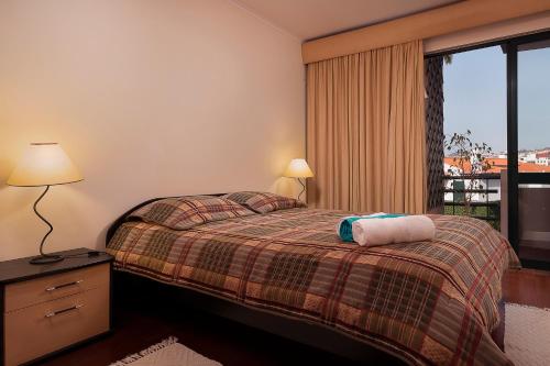 a hotel room with a bed and a window at Apartment Bay Historic Center in Funchal