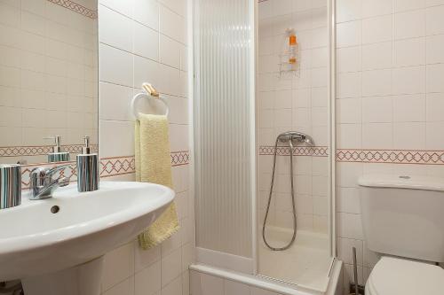 a bathroom with a sink and a shower at Apartment Bay Historic Center in Funchal