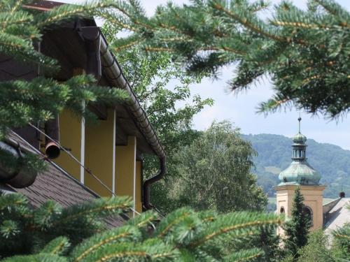 a building with a green roof and a tower at Hotel Formule in Děčín