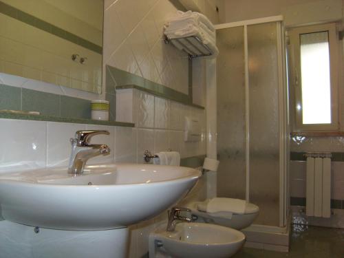 a bathroom with a sink and a toilet at Residence Torre Del Mar in Alba Adriatica
