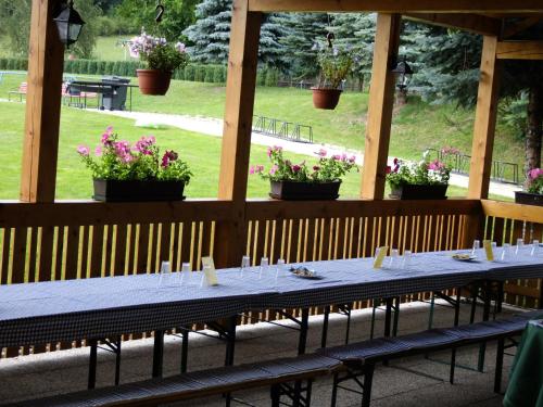 a long table in a pavilion with potted plants at Hotel Formule in Děčín