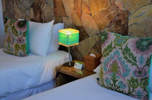 a bed with a table with a lamp on it at Mine Hotel in Buenos Aires