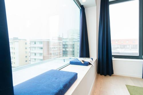 a bed in a room with a large window at Hotel Niedersachsen in Westerland (Sylt)