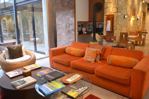 a living room with an orange couch and a table at Mine Hotel in Buenos Aires