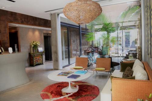 a living room with a table and chairs at Mine Hotel in Buenos Aires