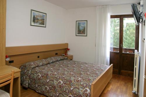 Кровать или кровати в номере Appartamenti Nigritella