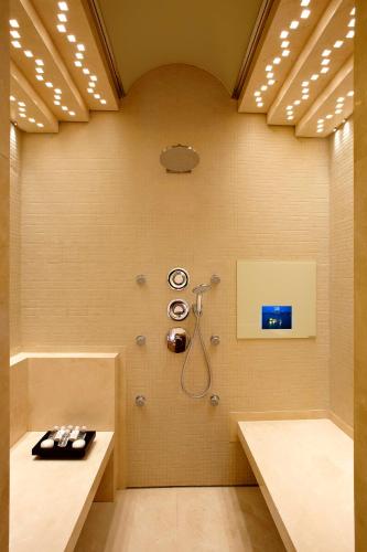 a bathroom with a shower and a sink at Nafplia Palace Hotel & Villas in Nafplio